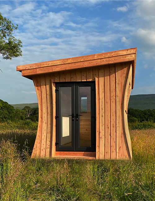 A unique concave wooden cabin by Wood Art