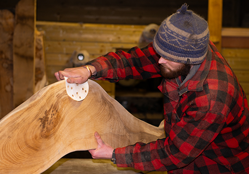 A man working on a piece of beautiful wood at Wood Art