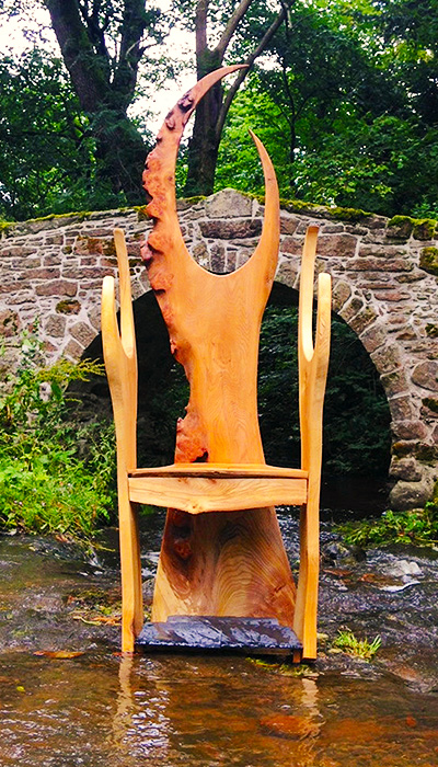 An elaborate wooden throne chair by Wood Art